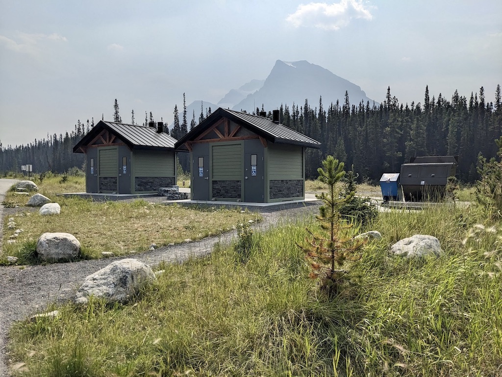 vault toilets and mountain view at Silverhorn Creek Campground Banff National Park