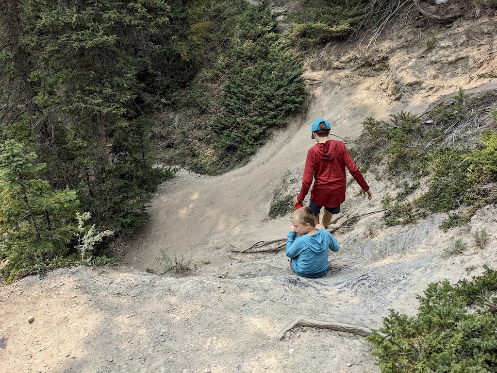 kids on steep trail to the river at Mistaya Canyon Canadian Rockies