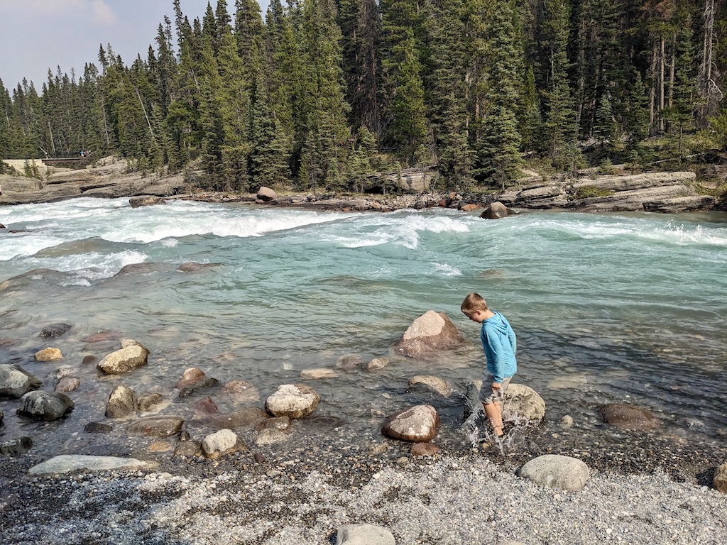 kid at the edge of the Mistaya River Alberta