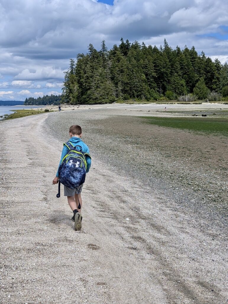 kid corssing the tombolo to McMicken Island Washington