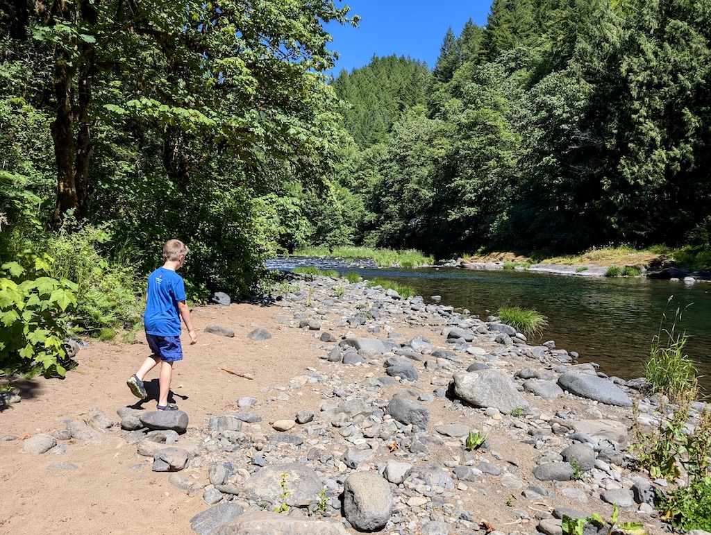 kid on the shore of the Wilson River Oregon Coast Range